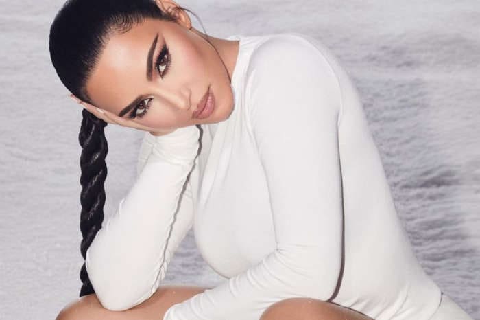 Kim Kardashian Puts Her Curves On Full Display In Two-Piece, Reflective Bathing Suit