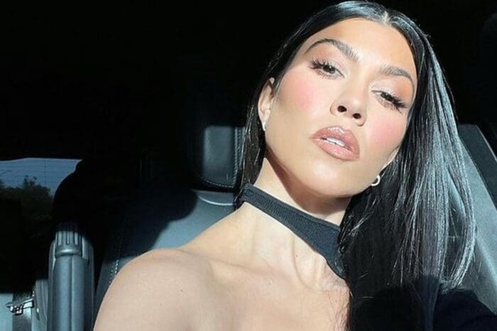 Kourtney Kardashian Strikes A Sultry Pose In Cut-Out Midi Dress