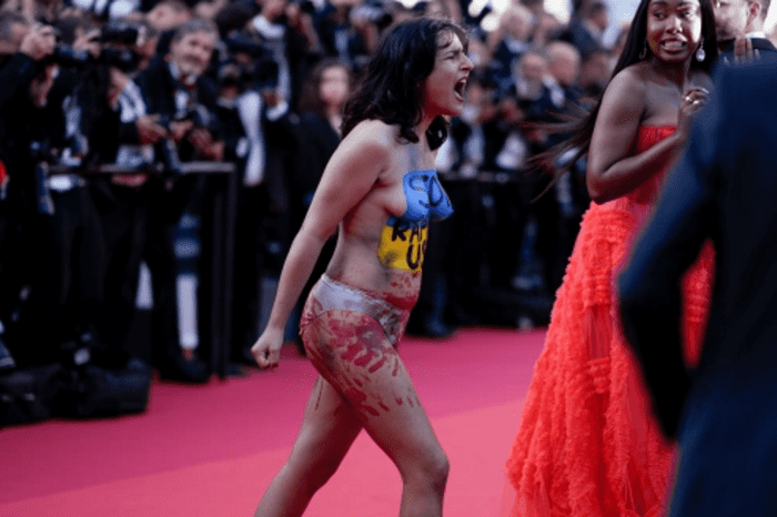 A woman in the colors of the flag of Ukraine ran topless on the red carpet in Cannes