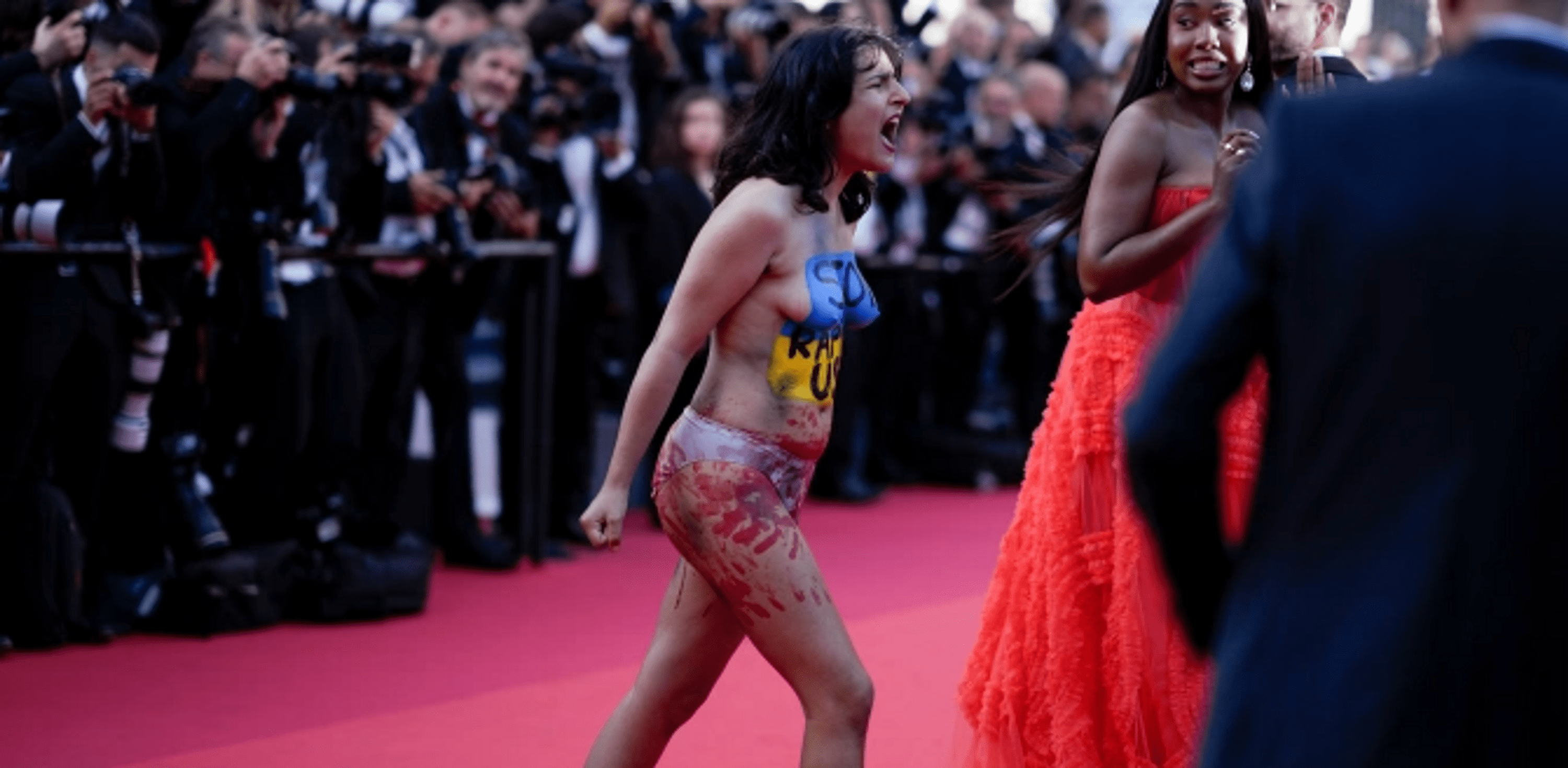 A woman in the colors of the flag of Ukraine ran topless on the red carpet in Cannes