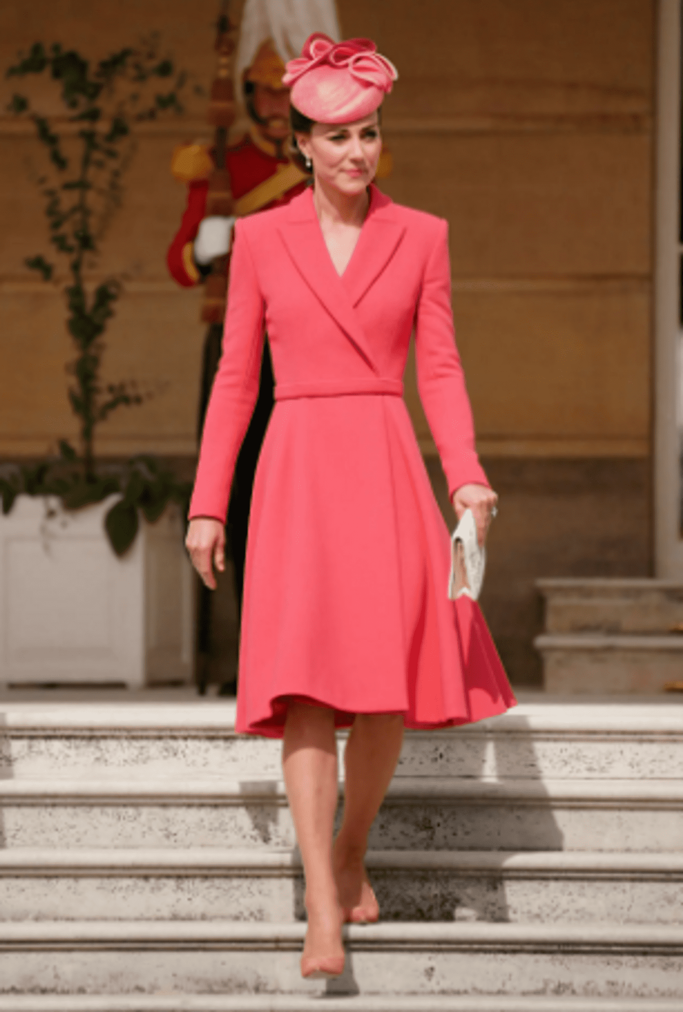 As always, the impeccable Kate Middleton in a coral coat dress receives guests in the garden of Buckingham Palace