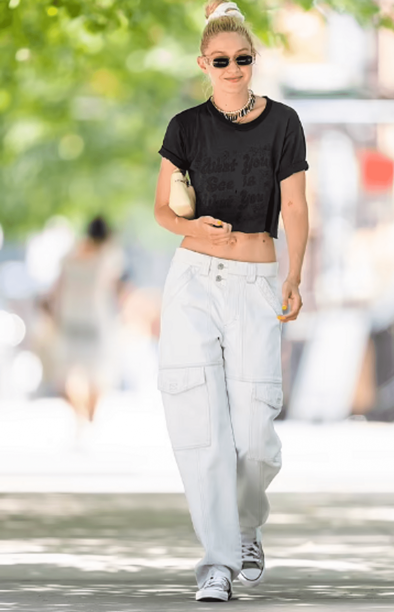 In A Low-Rise Pair Of White Slacks And A Black Crop Top, Gigi Hadid Appeared Beautiful And Carefree