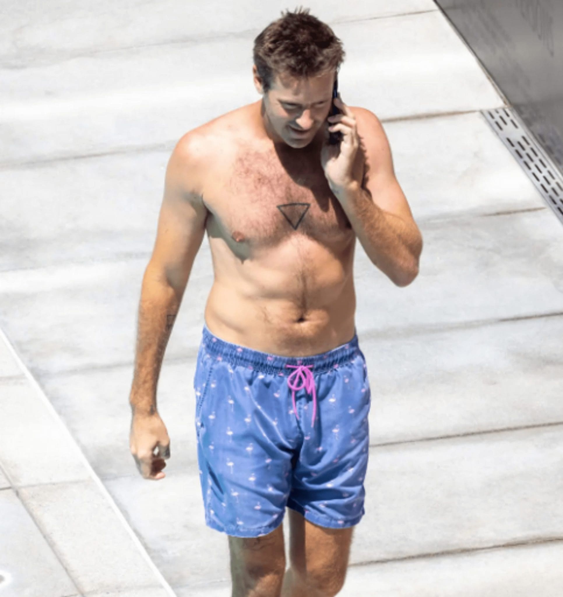 In a Southern California hotel, Armie Hammer was photographed by the pool with some fresh piercings on his arm and chest