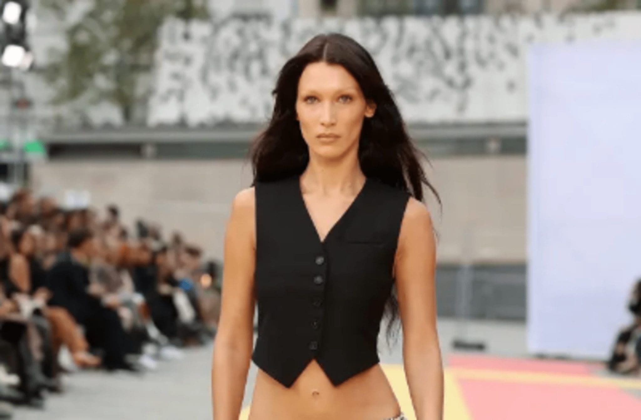 Bella walked the Stella McCartney runway without a bra, showing off a skintight, embroidered catsuit.