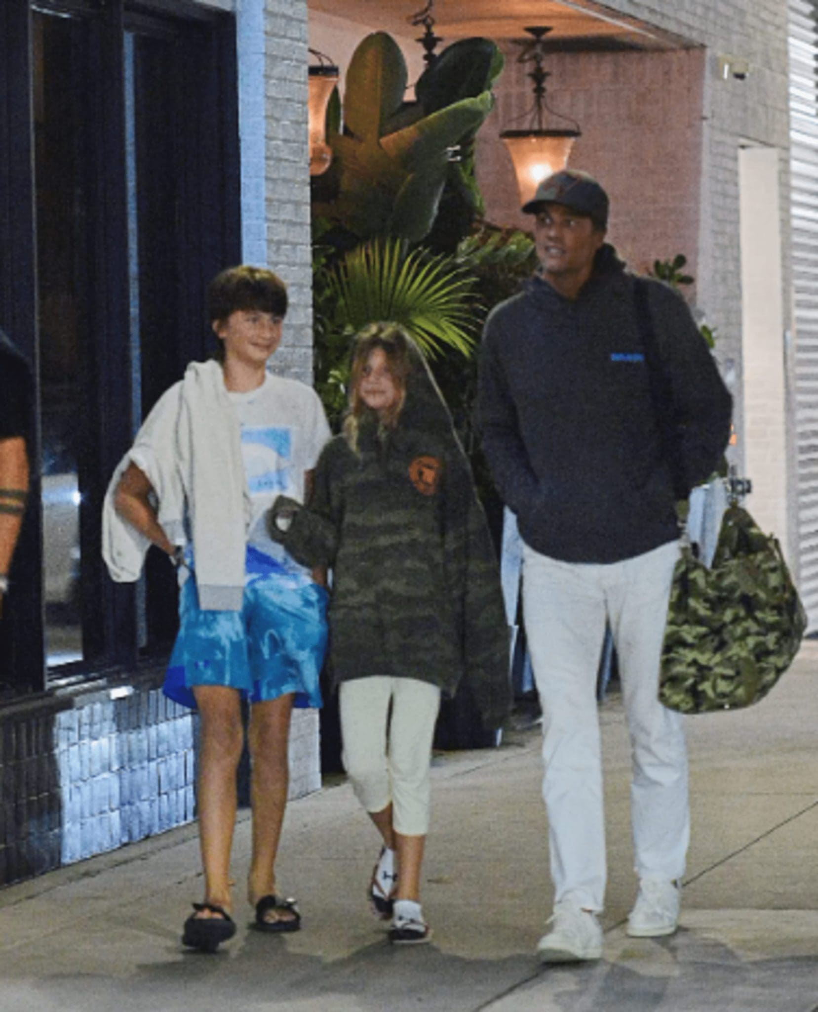 Having recently split from Gisele Bündchen, Tom Brady takes his children to the movies.